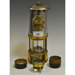 An Eccles Type 6 Miner's Protector lamp; a Victorian brass tripod lens,