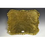 An Arts and Crafts brass shaped rectangular serving tray, embossed East West Home's Best, c.