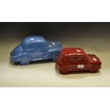 Decorative Ceramics - a pottery model of a Mini car, glazed in puce; another of a Morris Minor car,