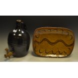 A stoneware Flagon, with a wooden tap; a stoneware art pottery charger,