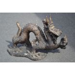 An Austin productions ceramic figure of a fanciful serpentine dragon. 57cm high x 87cm long.