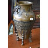 An oriental style bronze twin handle baluster vase, everted rim, embossed decoration,