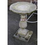 Garden ornaments - a reconstituted stone pedestal table, shaped circular top, baluster column,