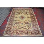 An Eastern rectangular wool rug, woven in the traditional manner with geometric motifs,