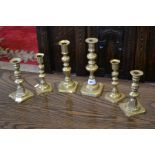 A pair of brass candlesticks with pushers, 6 inches tall; another pair,