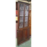 A 19th century mahogany floor standing splay fronted corner cupboard