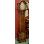 An oak cased grandmother clock, arched face with gilt metal spandrels, silvered chapter ring,