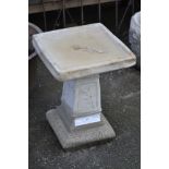 Garden ornaments - a reconstituted stone bird bath, dished square top, spreading square column,