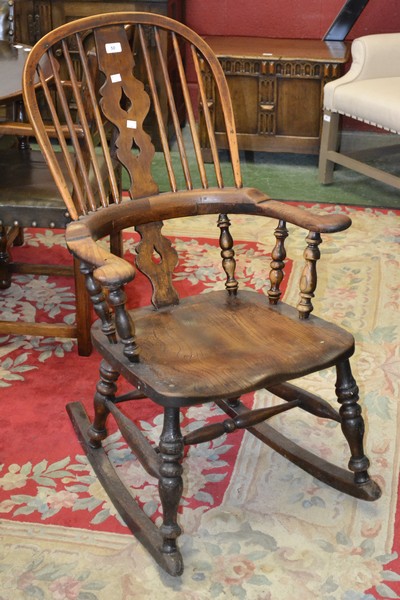 An ash and elm Windsor rocking chair, hooped back, pierced splat,