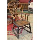 An ash and elm Windsor rocking chair, hooped back, pierced splat,