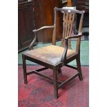 A George III open arm chair, shaped top rail, pierced splat, drop in seat.