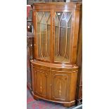 A yew floor standing corner cupboard