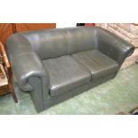 A green leather two seat settee
