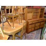 A Nathan Furniture teak extending dining table, four chairs and two carvers; a retro teak wall unit,