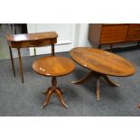 A reproduction walnut serpentine fronted hall table with two single drawers;