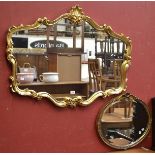 A large gilt framed wall mirror, moulded with s-scrolls,