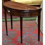 A George III mahogany tea table, demi-lune fold over top, deep frieze, tapering square forelegs,