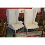 A pair of OKA Furniture, Knutsford wing back fireside armchairs. high back, scrolling arms.