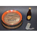 A Guinness stout barrel ashtray; Guinness bottle;