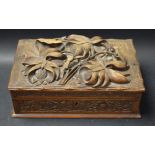 An early 20th century wooden box, carved with birds,