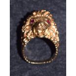 A 9ct gold lion head signet ring, pink garnet eyes, stamped 375, London 1957, 20.