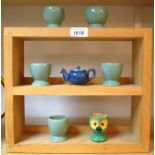 A Denby miniature teapot, electric blue; a set of five egg cups, green; another novelty egg cup,