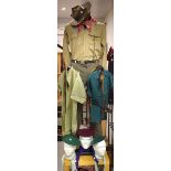 A Boy Scout uniform c1950s; another, later; belt, whistle, berets, pennants,