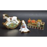 A Royal Crown Derby Treasures of Childhood miniature Ragdoll; others, Steam Train and Rocking Horse,