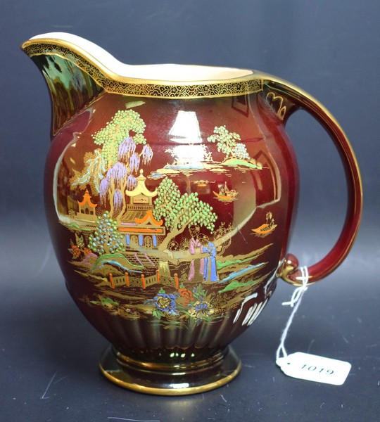 A Crown Devon Fieldings ovoid jug, rouge royale type lustre glaze, applied with pagoda,