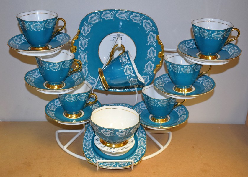 A Windsor tea service for six decorated with ripe fruits and vine leaves on a turquoise ground,