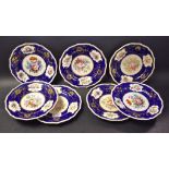 A set of Seven Bloor Derby plates, each painted with flowers within a cobalt blue and gilt border,