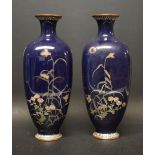A pair of enamelled blue vases