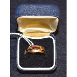 An 18ct gold ring, channel set with three square cut ruby stones, 4.