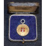 A gold fronted and enamel silver fob,