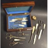 A Victorian Rosewood sewing box, containing mother of pearl handled sewing picks, scissors,