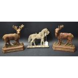Two vintage cast iron doorstops cast as stags;