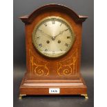 A mahogany inlaid mantel clock, twin winding holes, Roman numerals,brass feet,