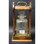 An oak single decanter tantalus,