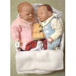 A pair of Ashton Drake baby doll models, The Twins, in blue and pink,