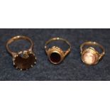 A smoky quartz solitaire dress ring, 9ct gold shank, size L; a garnet dress ring, 9ct gold shank,