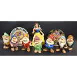 A set of Walt Disney Snow White and the seven dwarfs figures; a corresponding Wedgwood plate;
