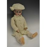 A Bruno Schmidt "Tommy Tucker" doll, bisque porcelain dome head and painted side part hair,