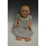 Armand Marseille - a German porcelain head baby doll.