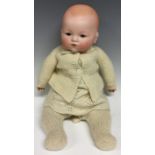 An Armand & Marseille bisque head baby doll, sleeping blue glass eyes, painted features,