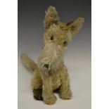 A Chad Valley Hygienic Toys Seated Terrier, straw stuffed grey body, plastic eyes,