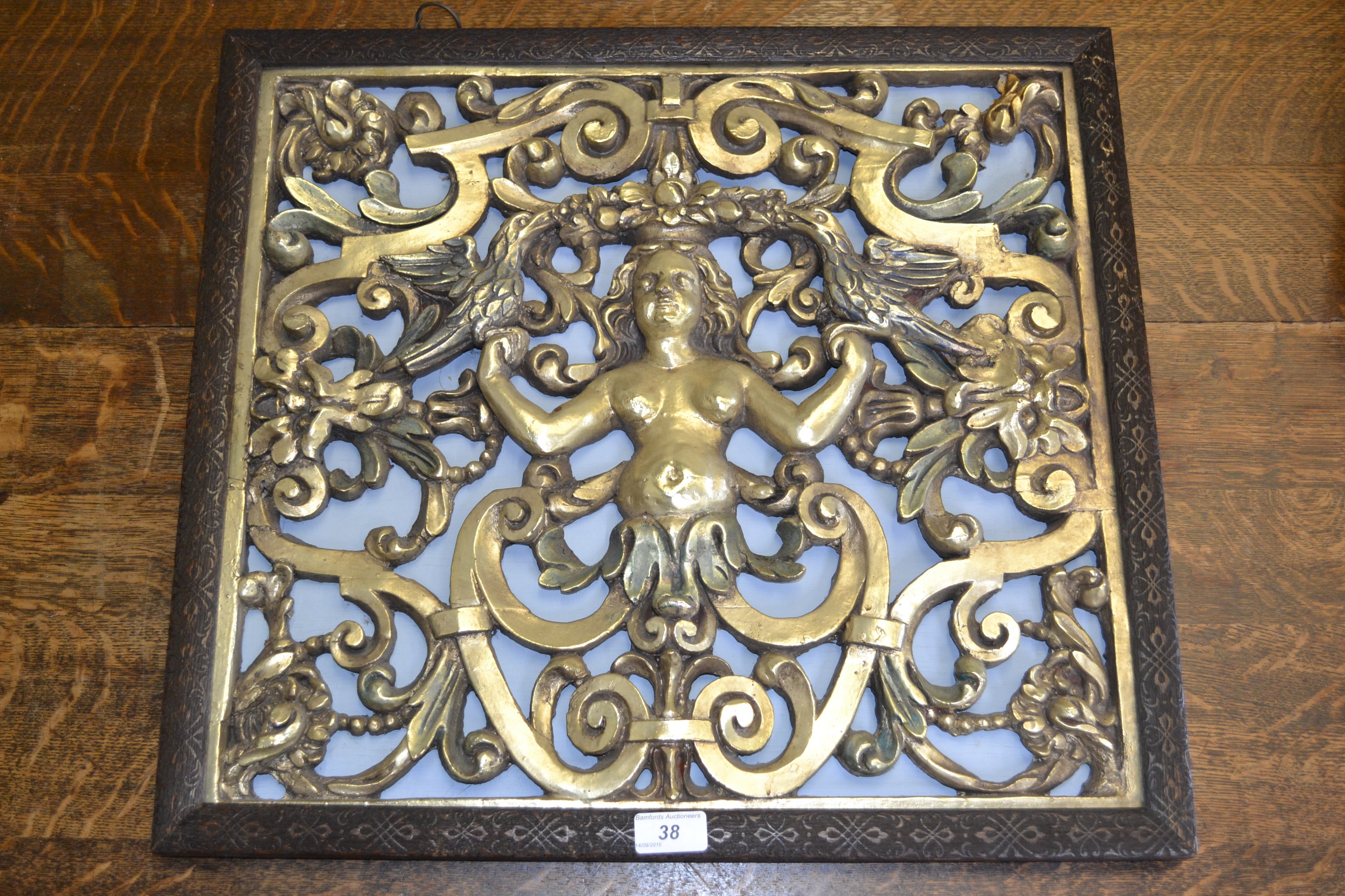 A figurative gilt panel, decorated with scrolls, figure and birds,