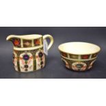 A Royal Crown Derby 1128 Imari cream jug; a sugar bowl similar,
