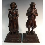 A pair of Flemish oak figures, carved as a merchant and his wife,