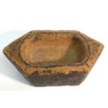 A 19th century Indian stone lozenge shaped votive bowl, the ends carved with stylised lotus,