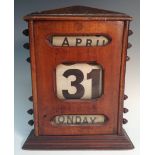 A large early 20th century mahogany perpetual desk calendar,